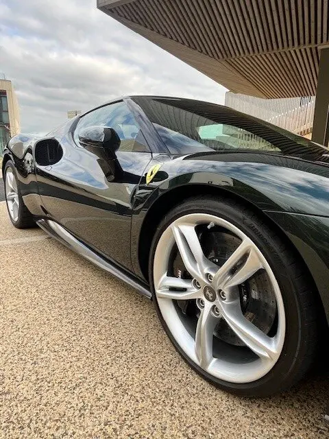 Black sports car alloy wheel and flank