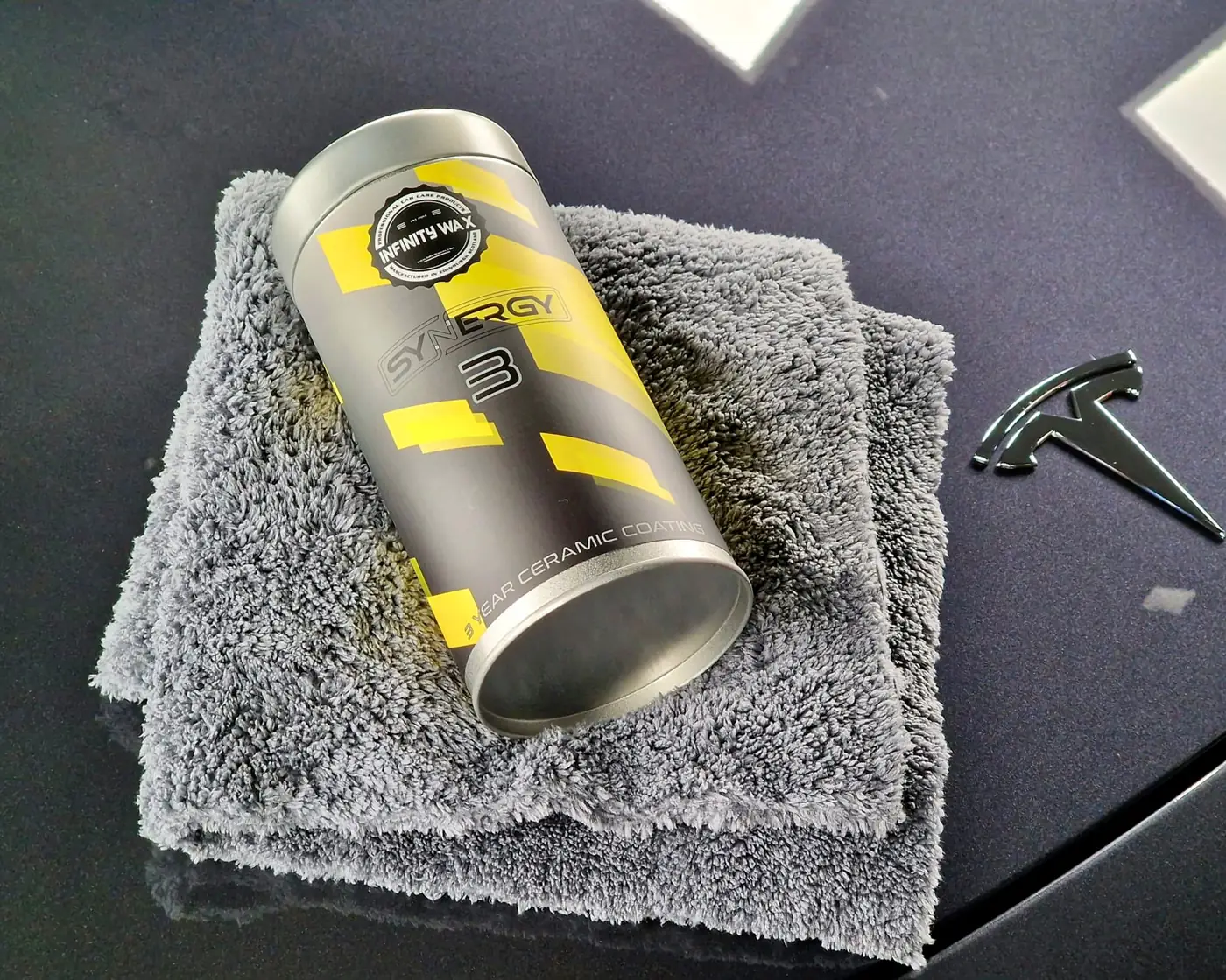 Infinity Wax Synergy ceramic coating bottle on a microfibre towel