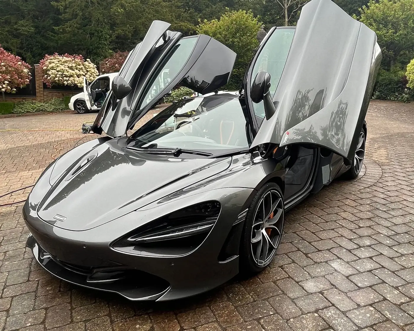 Grey McLaren 720S with its doors up after a full valet