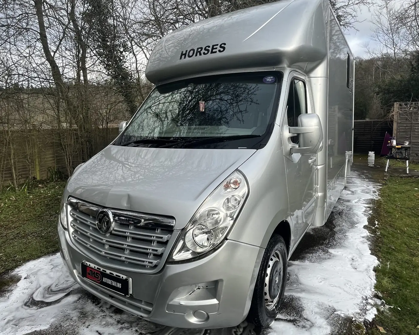 Silver horsebox covered in snow foam during a JMS clean