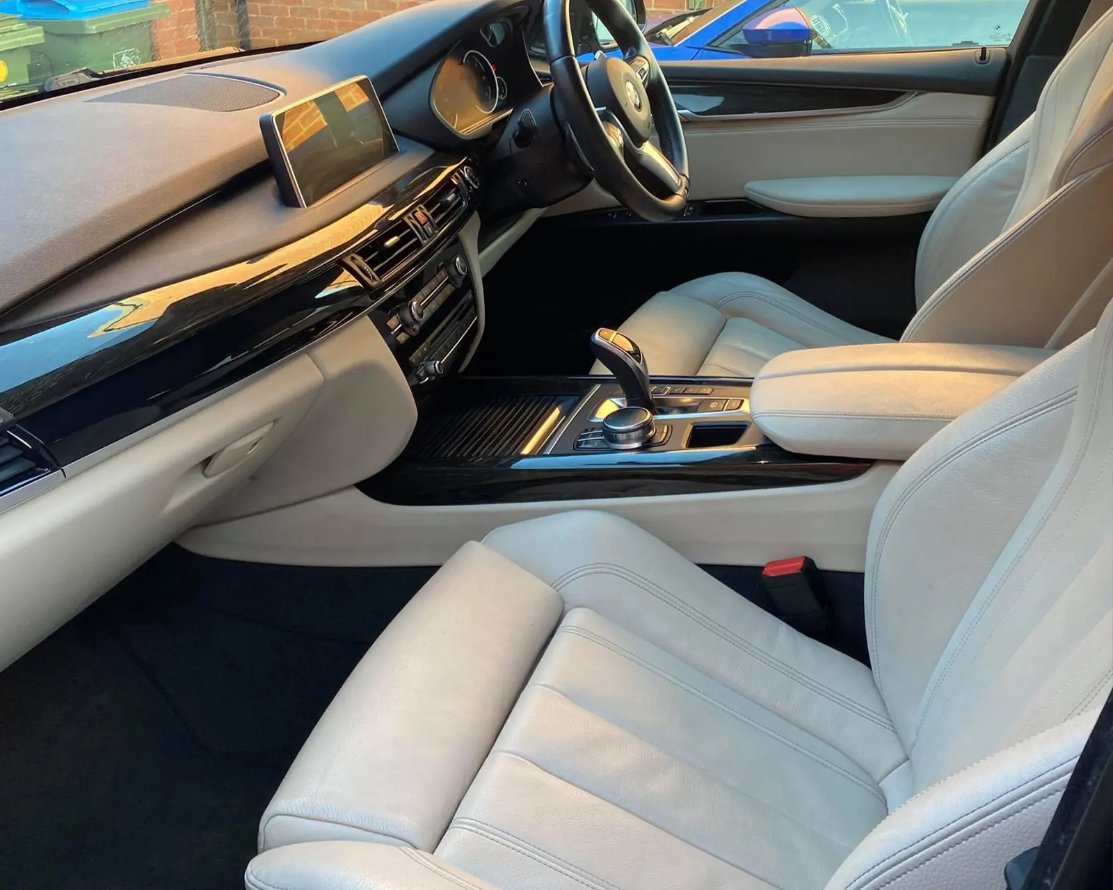 Clean white leather interior of a BMW X5