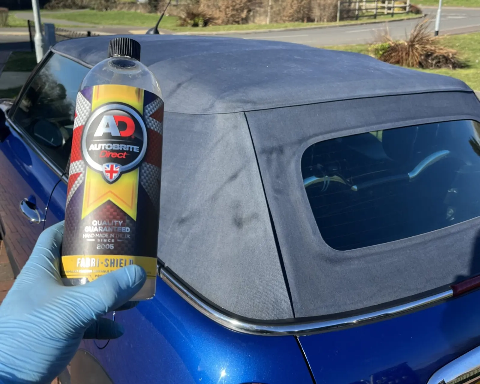 Blue convertible soft top being protected